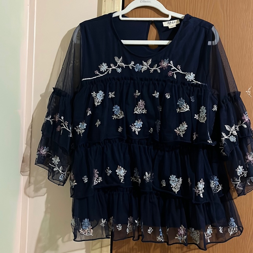 This is a floral navy blue shirt with ruffles